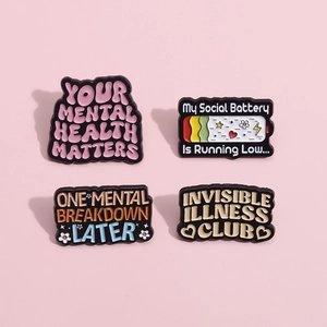 Mental health enamel pin set with positive quotes on a soft pink background