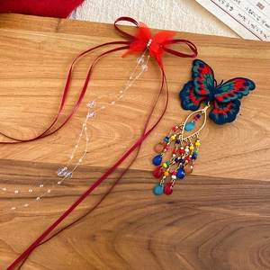Detail of Chinese style butterfly hair clips with embroidery, beads and long tassels
