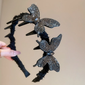Close-up of sparkling silver rhinestones on the butterfly fabric headband for women