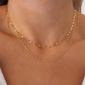 Close-up of double layered 18K gold plated stainless steel snake and textured leaf chain