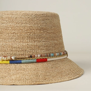 Handmade raffia straw sun hat with colorful beads, shells, and woven decorative bands