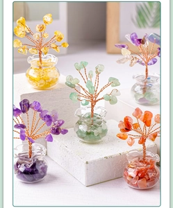 Macro detail of five colorful natural crystal stone trees in clear glass jars decor