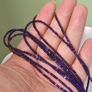 Close-up of 2mm metallic purple hematite cube beads for DIY jewelry making