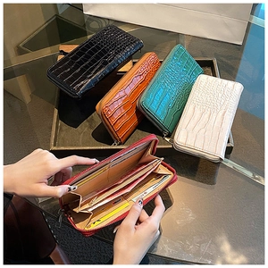 Close-up of crocodile pattern leather wallet interior with multiple card slots and zipper pocket