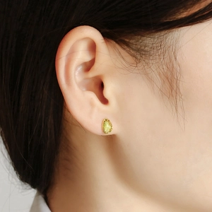 Close-up of S925 silver plated 14k gold earring with green pear-shaped gemstone