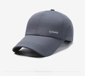 Detail of laser-cut ventilation holes and sports embroidery on breathable grey cap