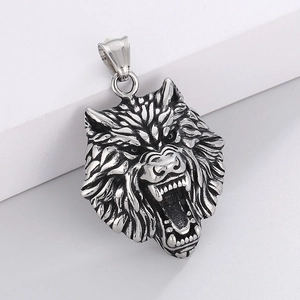 Detailed close-up of a silver wolf head pendant with vintage hip-hop carving details