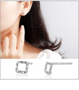 Detail of S999 sterling silver stud earrings with hammered irregular square surface
