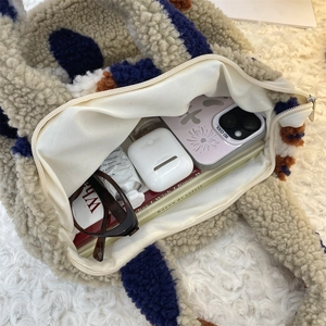 Detail view of large interior capacity and zipper closure in plush lunch tote bag