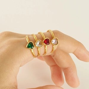 Colorful heart-shaped gemstone rings in gold plating shown on hand in various colors
