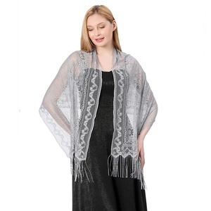 Close-up of silver lace shawl with floral embroidery and elegant long fringe trim