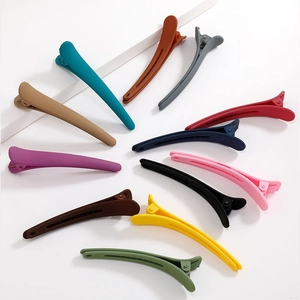 Set of 12 matte 8cm duckbill hair clips in assorted colors on white background