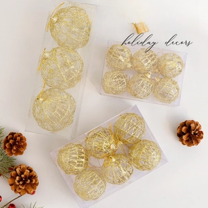 Golden hollow Christmas ball ornaments with pine cones for festive tree decoration