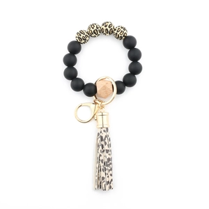 Detail of leopard print beads keychain with silicone spheres and a leather tassel