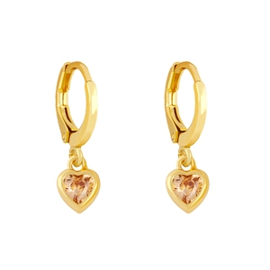 Macro shot of gold heart-shaped earrings featuring champagne zircon stones in detail