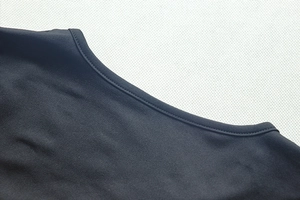 Close-up of the elegant round neckline and detailed stitching on this black long dress