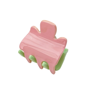 Mini candy-colored pink and green hair claw clip for girls with glossy wavy texture