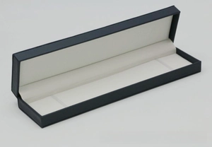 Detail of blue PU leather rectangular gift box with white elastic bands and creamy interior
