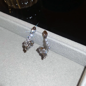 Macro shot of silver snake ear cuff with sparkling zircon on a velvet jewelry box