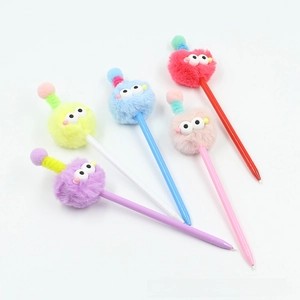 Flat lay of five colorful fuzzy monster pens with pom-poms and googly eyes on top