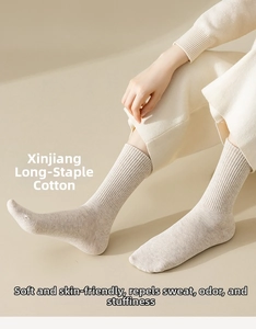 Detailed macro view of the soft ribbed cotton texture and light grey cotton crew socks