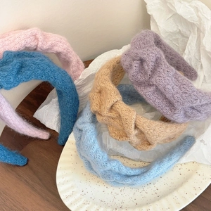 Collection of soft knitted wide twisted headbands in pastel blue, pink and purple tones