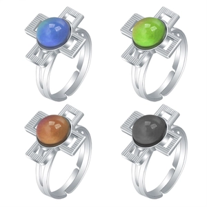 Detail view of four vintage adjustable rings with colorful thermochromic cross stones