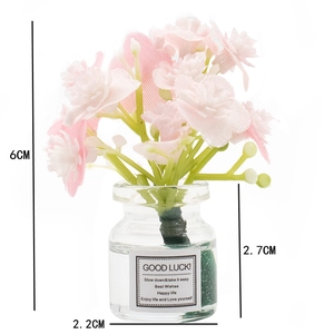 Mini glass vase with pink and white artificial flowers and GOOD LUCK label, 6cm height