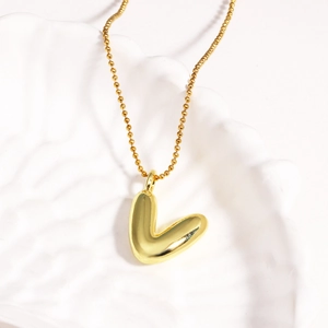 Close-up of a high-shine gold-plated 3D bubble letter L pendant on a fine O-chain necklace