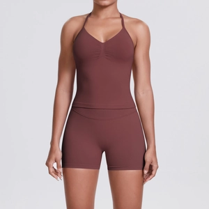 Detail view of brick red ribbed yoga set showing V-neck crop top and high waist shorts