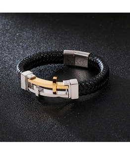 Detail of woven black leather bracelet with stainless steel clasp and golden cross charm