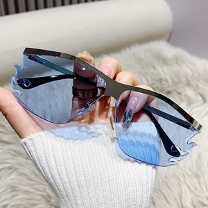 Futuristic flame shaped rimless sunglasses with silver metal frame and blue lenses