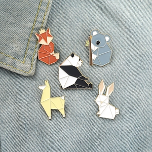 Geometric origami animal enamel pins set with fox panda and koala on denim fabric