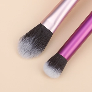 Macro shot of dual-tone makeup brushes with soft fiber bristles and metallic handles