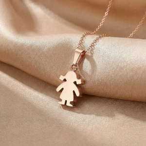 Macro shot of rose gold little girl pendant necklace on premium champagne silk fabric