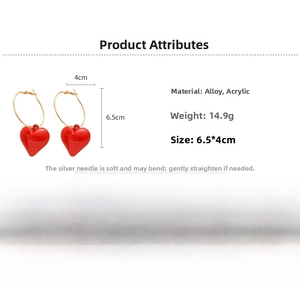 Detail view of red heart drop earrings with alloy hoop and acrylic charm specifications