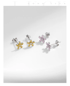 Macro view of S925 sterling silver flower stud earrings with colorful enamel and diamonds