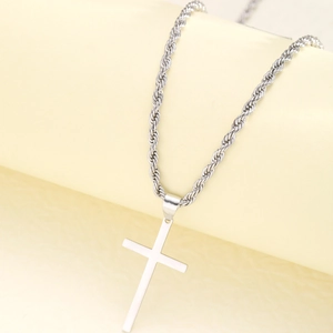 Detailed view of silver stainless steel cross pendant on a classic rope chain necklace