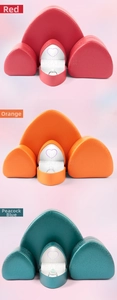 Close-up of heart-shaped LED jewelry boxes in red, orange, and teal with rings
