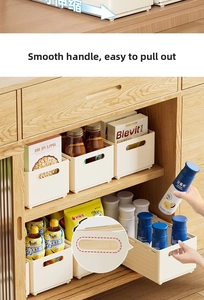 Detail view of smooth rounded handle on cream retractable cabinet storage box