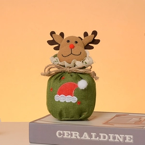 Detail of Christmas burlap gift bag featuring plush reindeer decoration and lace bow