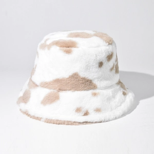 Macro detail of cow print faux fur texture and fluffy material on a winter bucket hat