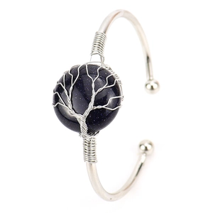 Detail of handmade silver wire wrapped bangle with blue sandstone and tree of life design