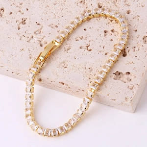 Detailed macro view of golden V-shape bracelet with square zircons on beige stone base
