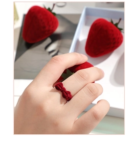 Detailed view of red strawberry velvet ring box with cute bow and adjustable ring display
