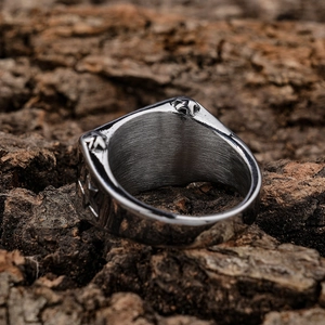 Vintage silver stainless steel ring with 3D star motif on natural wood background