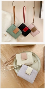 Macro detail of embossed rose patterns on PU leather wallets in assorted pastel colors