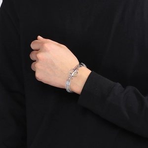Close-up of men's double-row silver stainless steel Cuban bracelet with an anchor charm