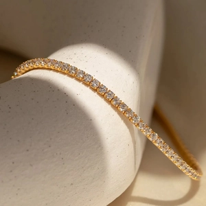 Classic gold-plated tennis bracelet featuring a row of sparkling round-cut cubic zirconia
