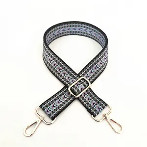 Macro detail of ethnic geometric woven strap with purple patterns and gold metal buckles